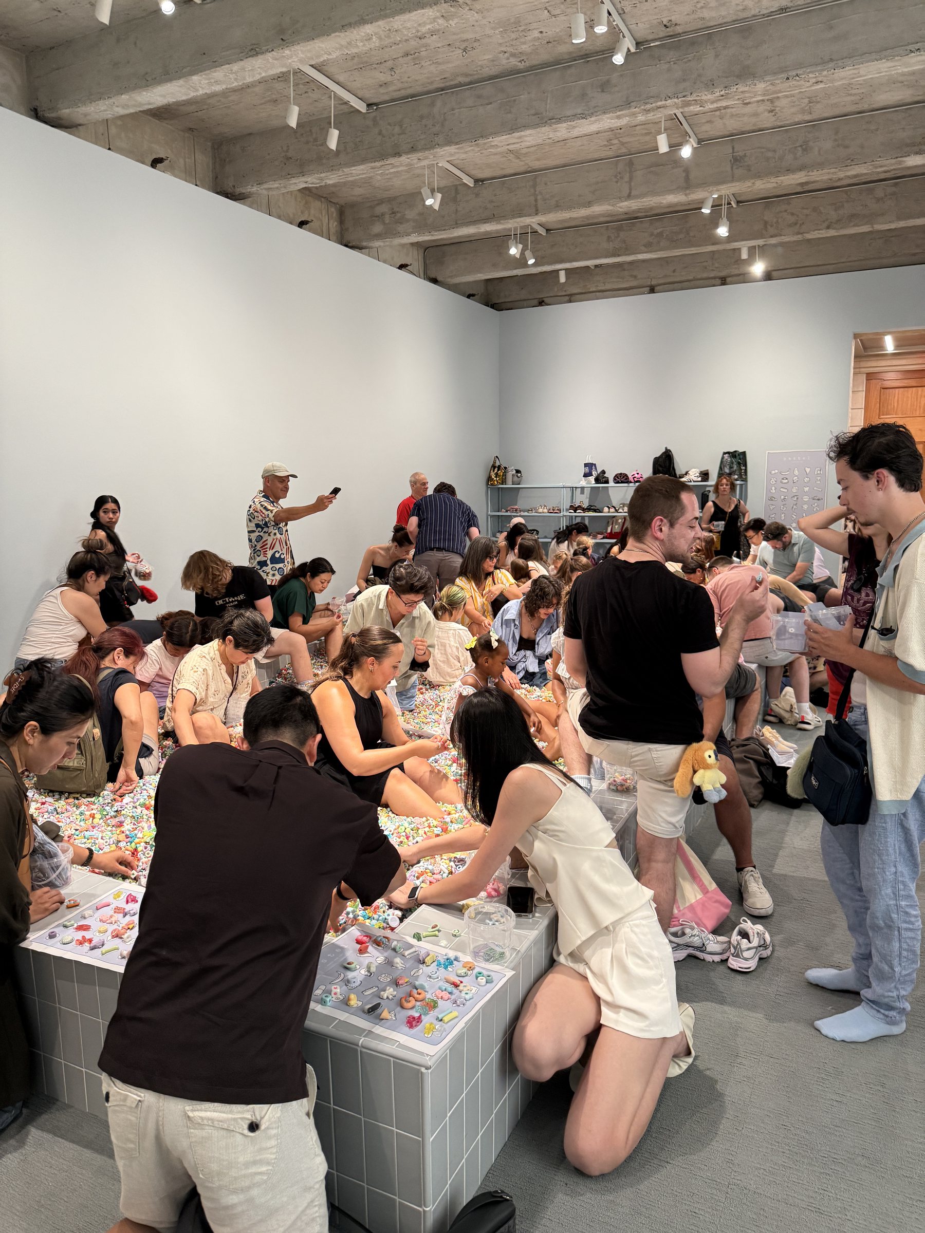 Visitors reaching into the bead pit