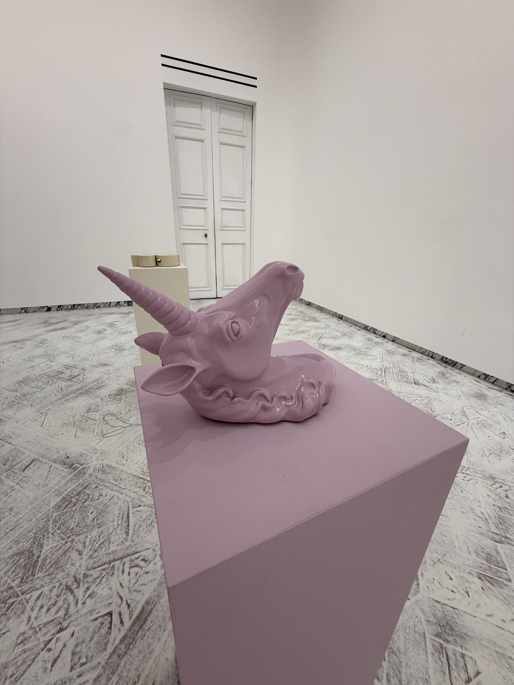 An oversized lavender unicorn head sculpture