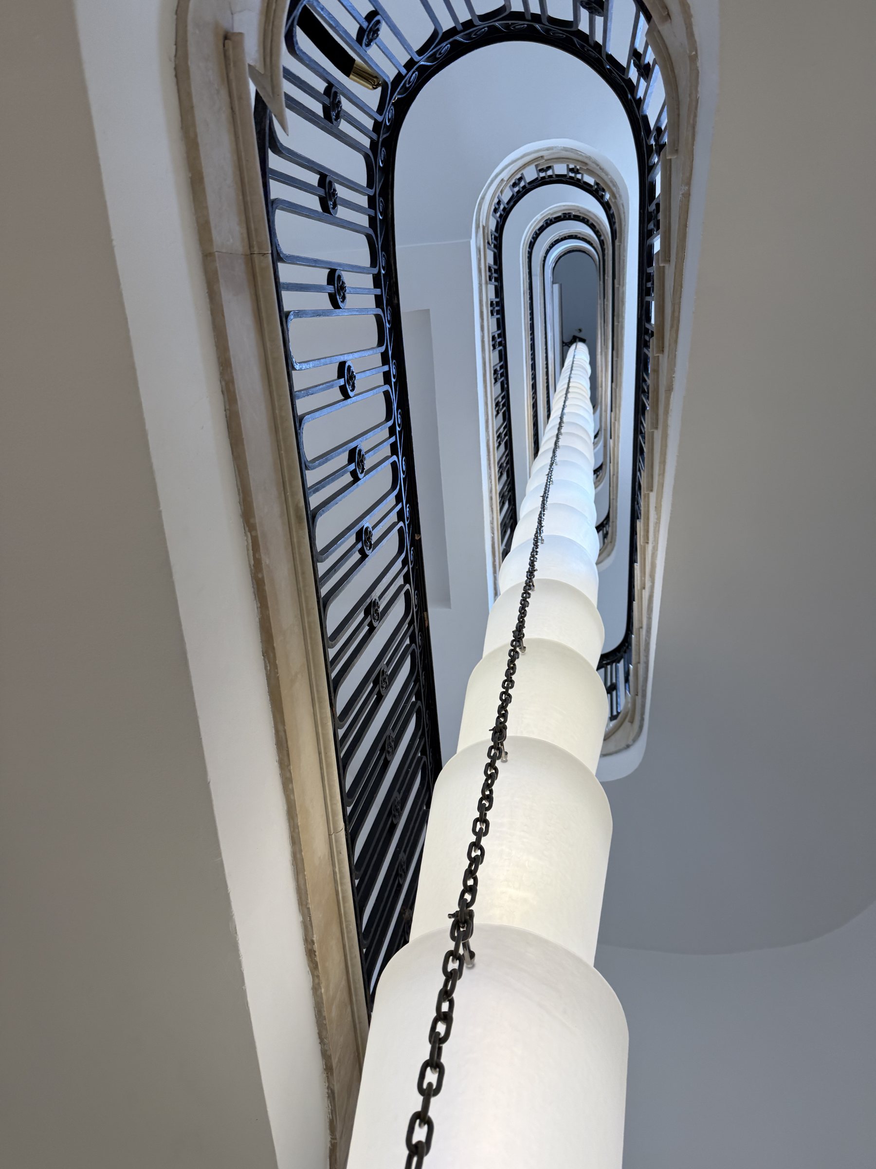 A spiral staircase inside the townhouse, a chain of lights strung down the center
