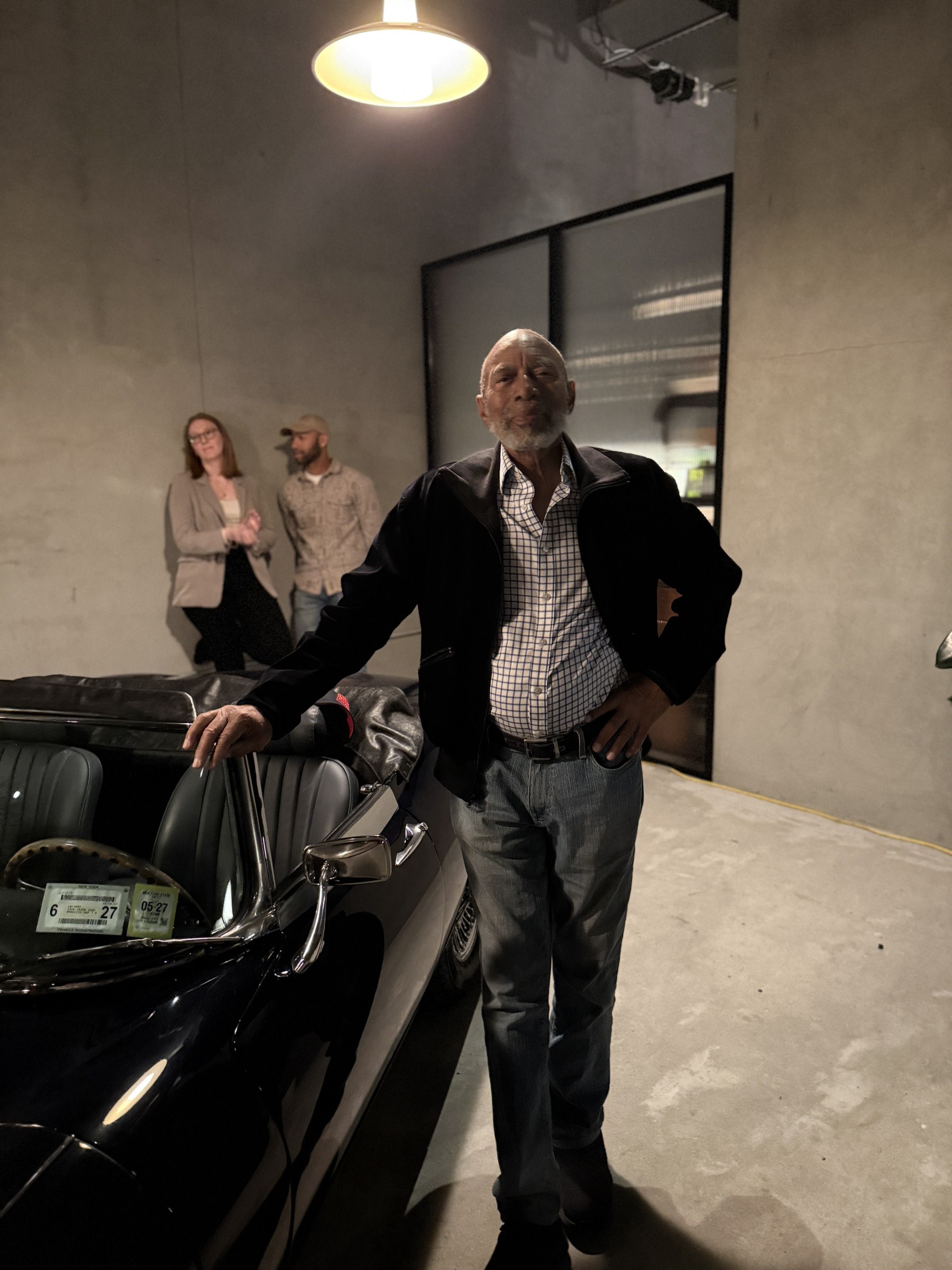 George standing beside his E-Type Jaguar