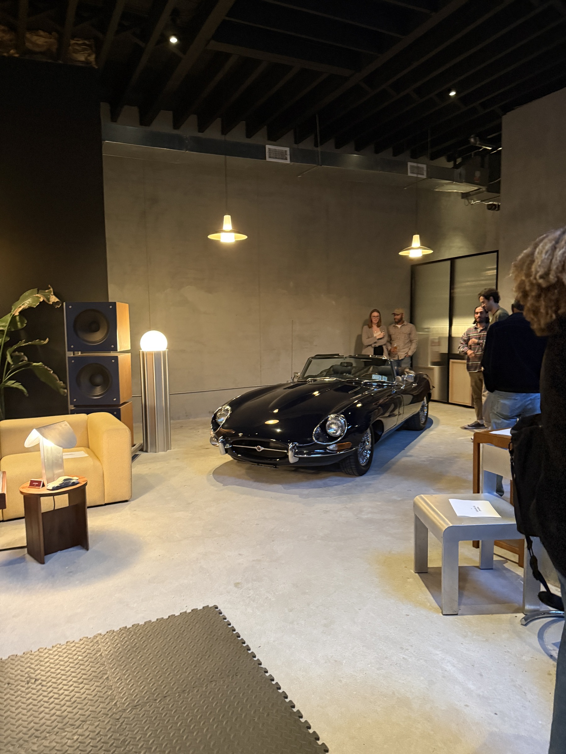 The room at Car Part Time with the Jaguar parked at the end
