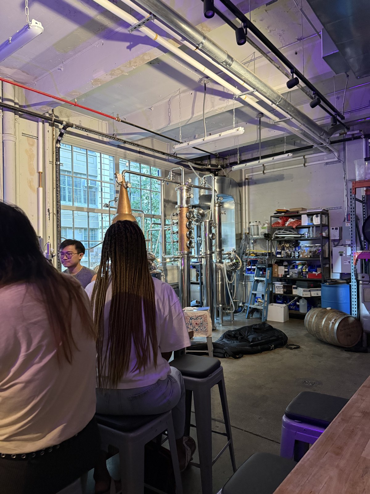 The crowd at Fort Hamilton Distillery with the copper still visible in the background