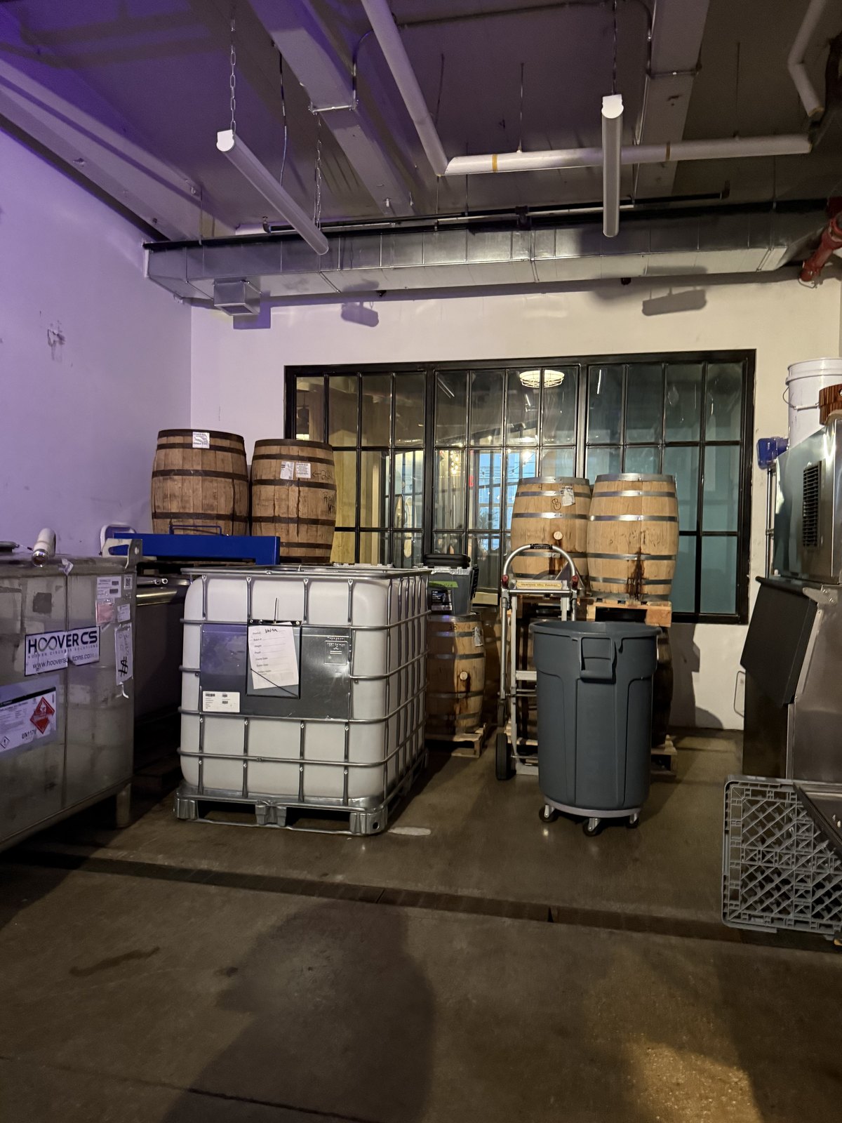 Barrels and equipment along the wall at Fort Hamilton Distillery